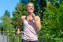 Happy healthy woman jogging outdoors