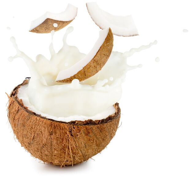 coconut milk and pieces spilling out half nut